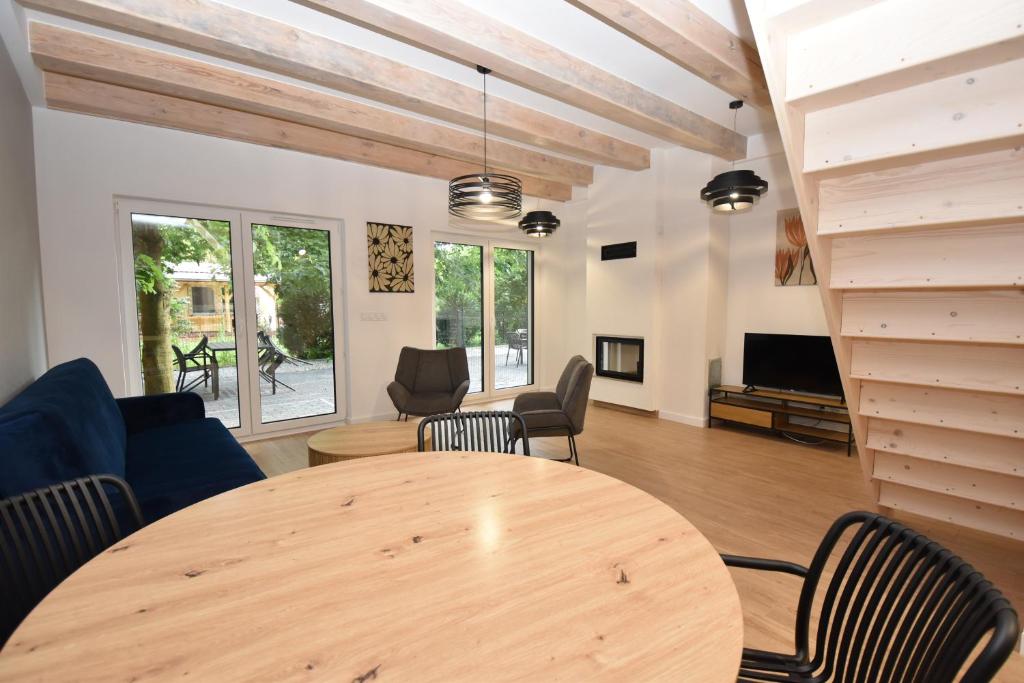 a living room with a wooden table and chairs at Turawski Zakątek in Turawa
