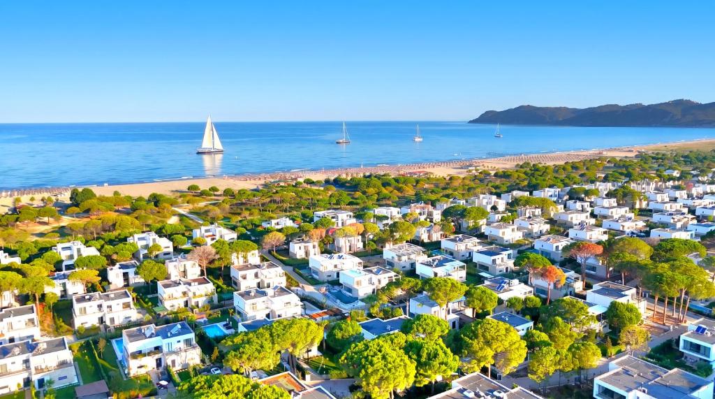 an aerial view of a beach with houses and a sailboat at Bay Breeze 293 in Lalzit Bay