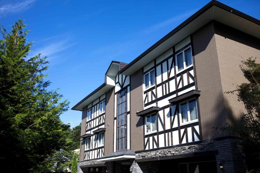 a building with black and white windows on it at Hotel Karuizawa Elegance in Karuizawa