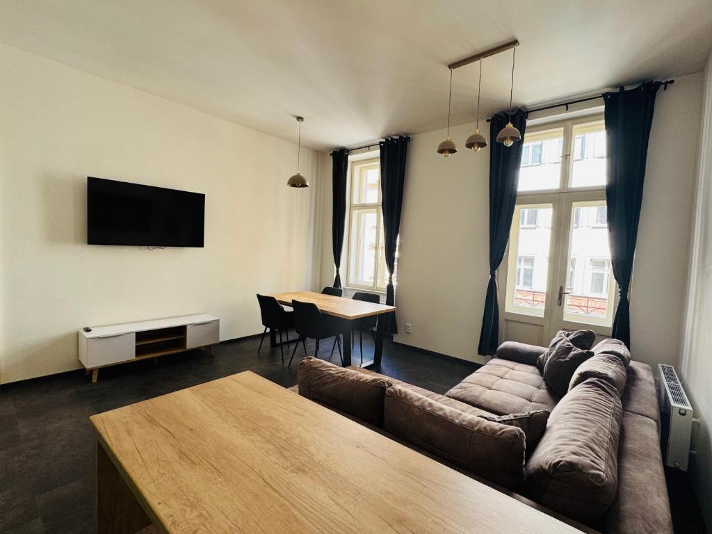 a living room with a couch and a table at Perlová Suites in Pilsen