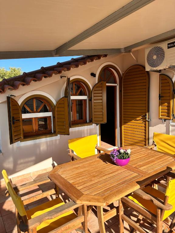 a wooden table and chairs on a patio at Tproject in Preveza