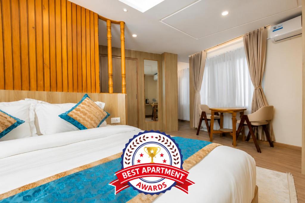 a hotel room with a bed with a best apartment sign on it at Tritara Apartment in Kathmandu