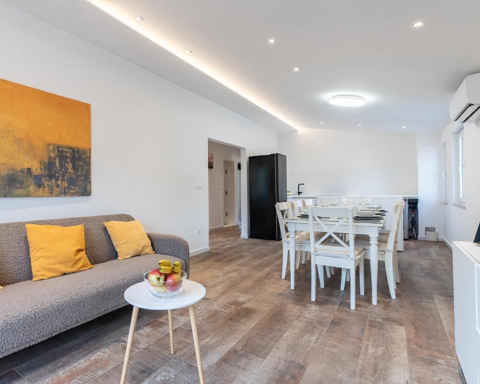 a living room with a couch and a table at Villa Omaha in Vekići