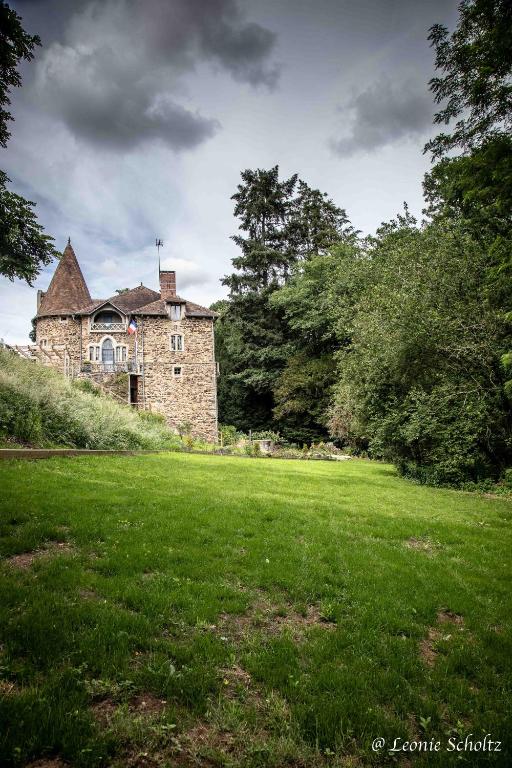 an old stone house in a field of grass at Château de Najade in Sainte-Sévère-sur-Indre