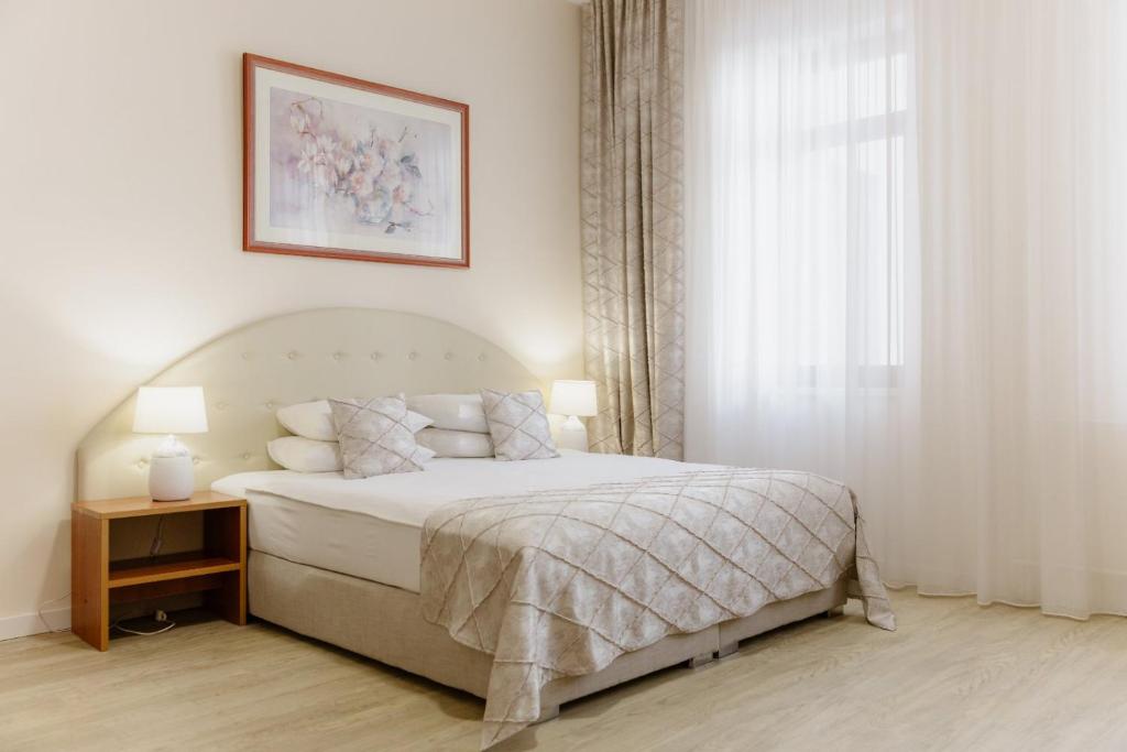 a bedroom with a bed and a window at Hotel N in Belgrade