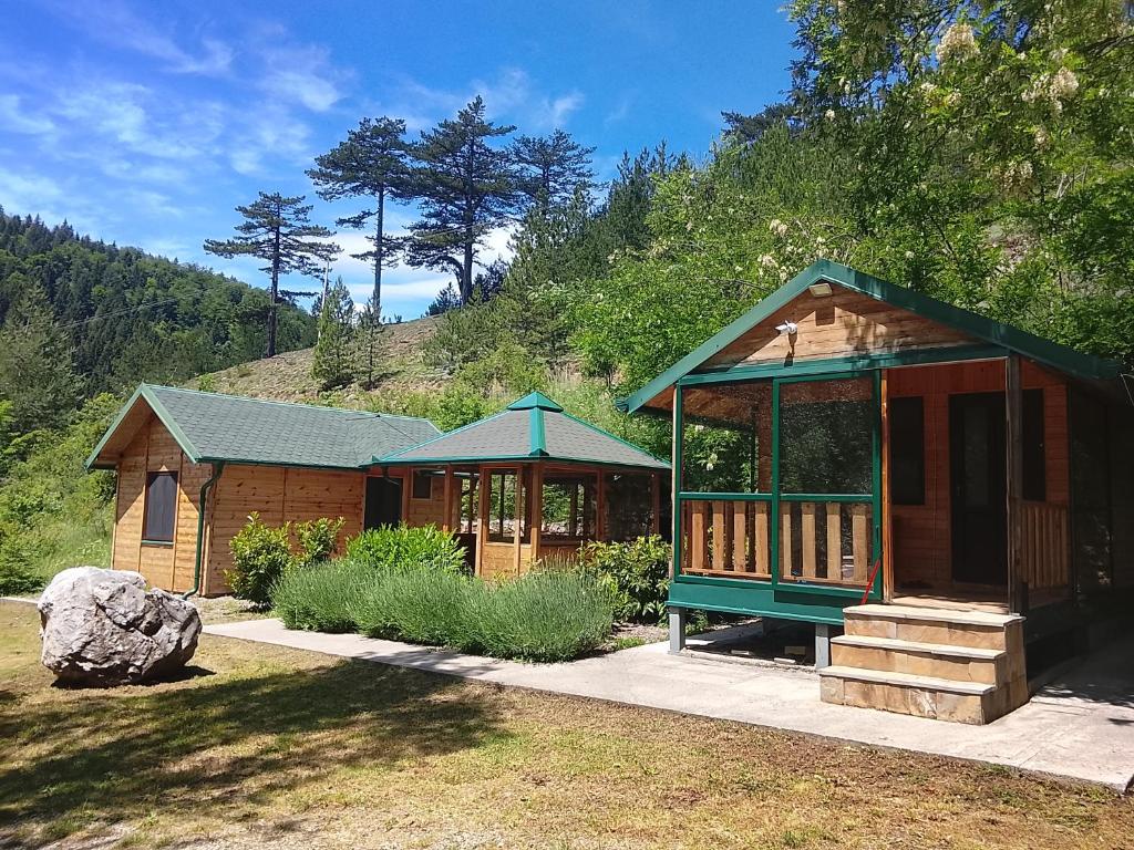 a wooden cabin with a gazebo in a yard at Air Zaovine in Bajina Bašta