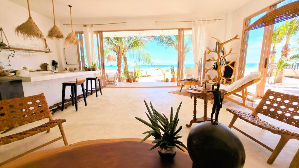 a living room with a view of the ocean at Tides Signature Koh Chang in Ko Chang