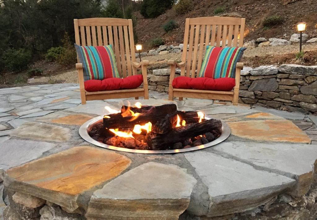 two chairs and a fire pit on a patio at Oak Hill On Love Lane Bed and Breakfast Inn in Waynesville