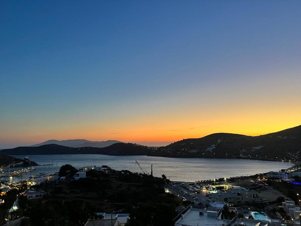 a view of a city and a lake at sunset at Princess Sissy in Ios Chora