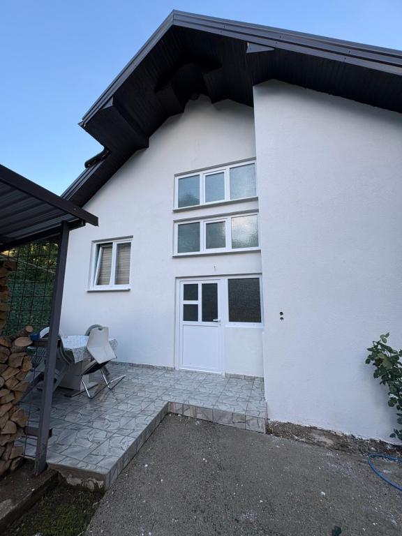 a white house with a door and a patio at Canovic vacation in Plav