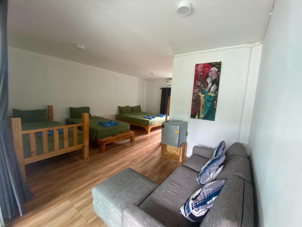 a living room with a couch and a table at PD RESORT Kohkood in Ko Kut