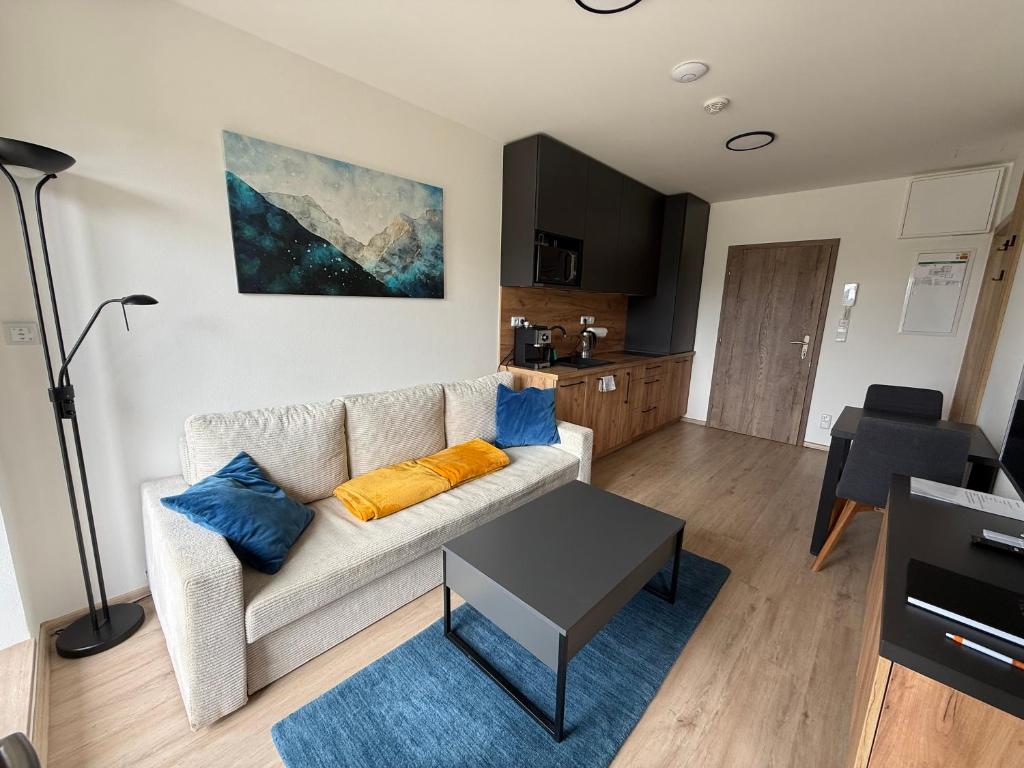 a living room with a couch and a table at Apartmán Valašský Eden in Horní Bečva