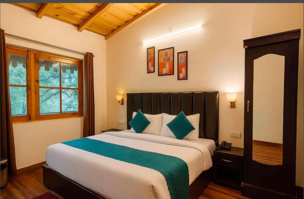 a bedroom with a large bed and a window at The Woods Boho in Nainital