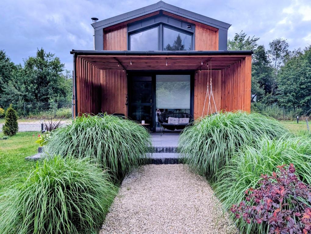 a house with a glass door and grass at Sub Silva in Bałtów