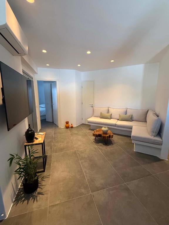 a living room with a couch and a table at Maison Blanche in Vóthon