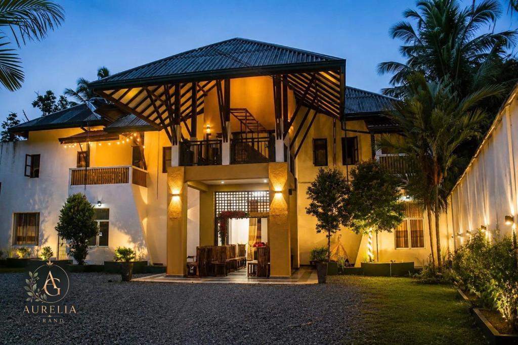 a large house with a balcony and a courtyard at Aurelia Grand Hotel in Kitulgala