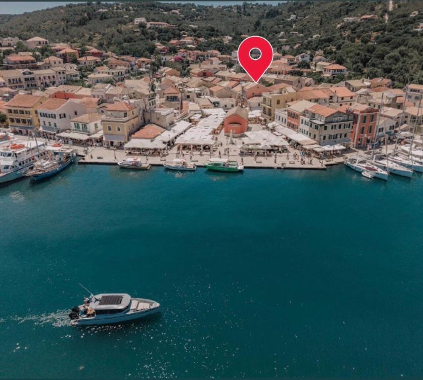 a boat in a harbor with a red marker at Luminis Residence by All about Paxos in Gaios