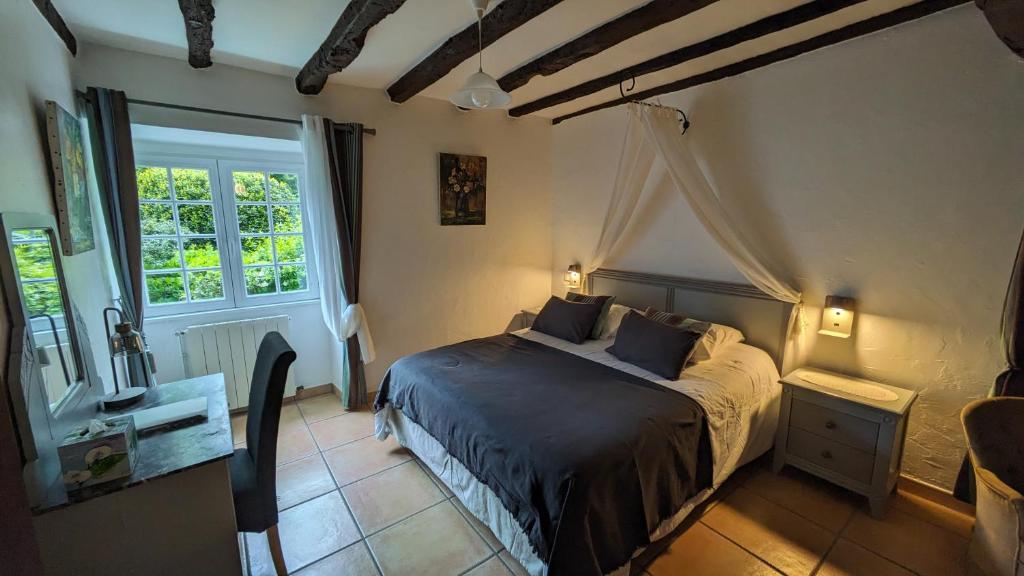 a bedroom with a bed in a room with a window at Maison d'hôtes de charme ttakoinenborda in Sare