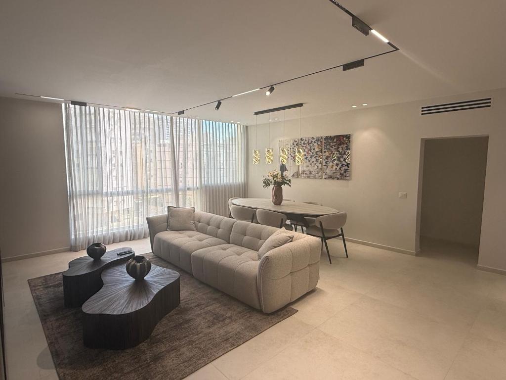 a living room with a couch and a table at Nitza 14 in Netanya