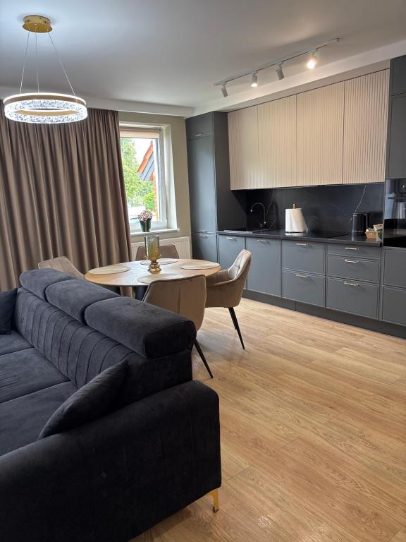 a living room with a couch and a table at Apartament Symsar in Lidzbark Warmiński