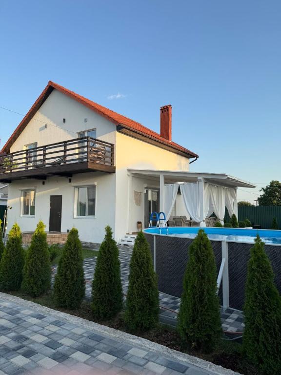 a house with a swimming pool in front of it at Villa Menorca in Chornomorsk