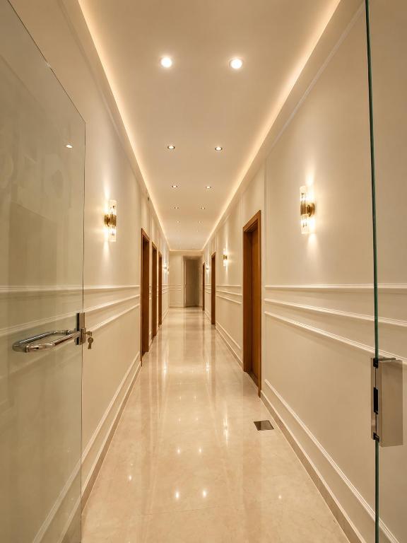 a corridor of a building with a glass door at Havana ViP in Cairo