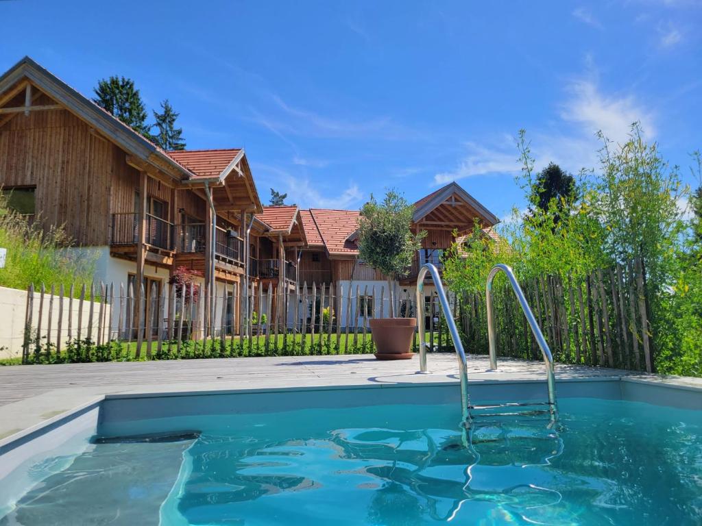 a swimming pool in a yard with a house at Bergmichlhof in Ragnitz