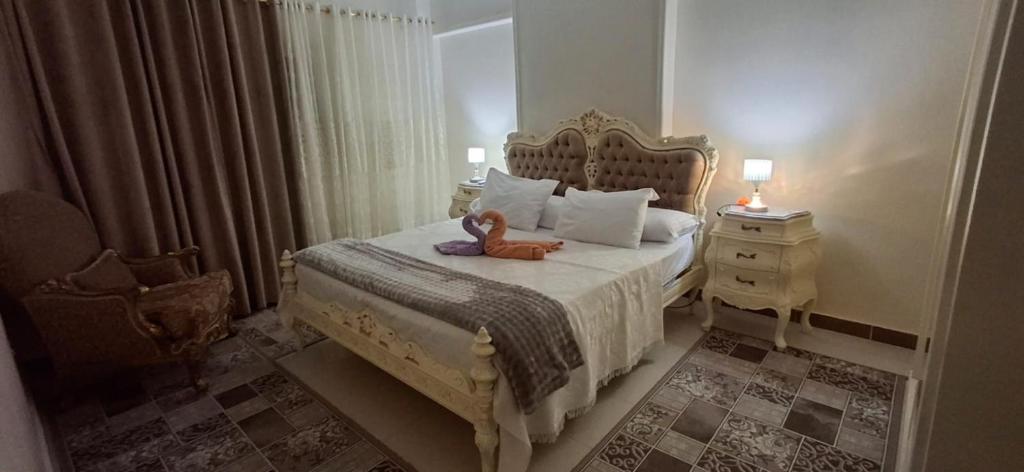 a bedroom with a bed with a teddy bear on it at Classic Seaview in Alexandria