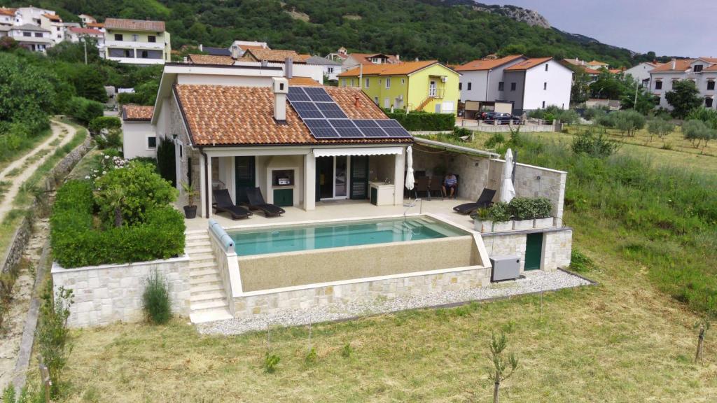 an aerial view of a house with a swimming pool at Villa Dupini in Baška