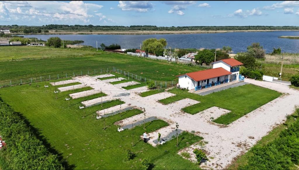 an aerial view of a large garden next to a body of water at Cameră de inchiriat și Camping La Agop in Murighiol