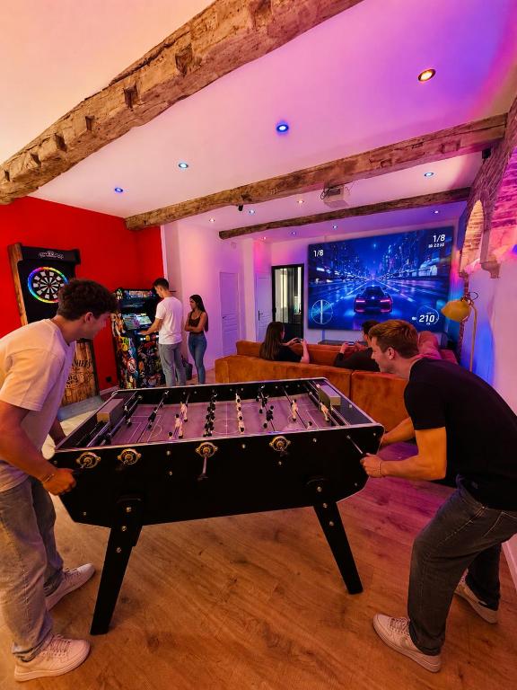 a group of men playing with a pool table at Quartier Général des Gamers Arcade Terrasse in Saint-Omer
