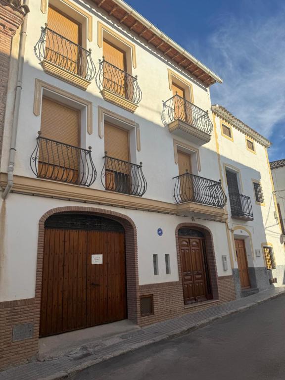 a building with two garage doors and two balconies at Los Balcones de San Marcos in Galera