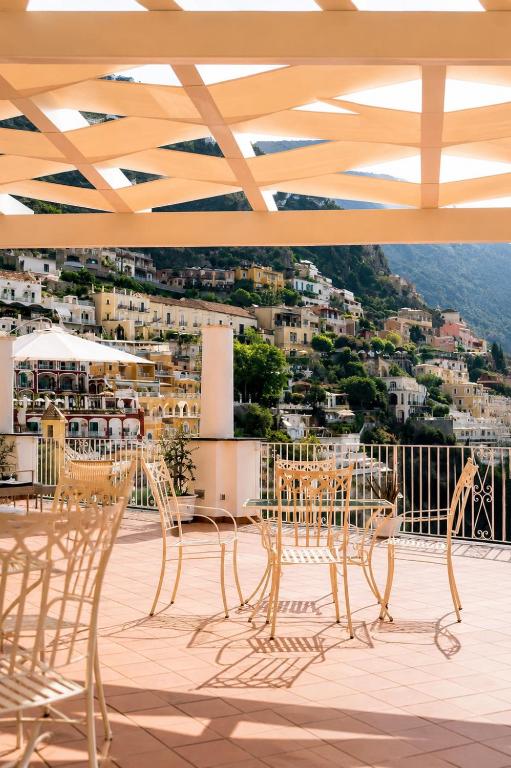 a group of chairs and tables on a roof at La Terrazza del Sole a Positano in Positano