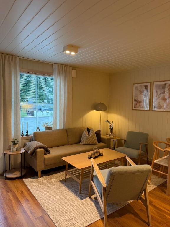a living room with a couch and a table at Gateway to Jotunheimen 4 Guests in Øvre Årdal