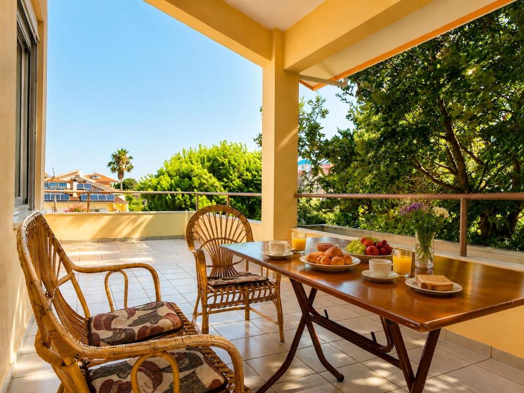 a table and chairs on a patio with a view of a balcony at Villa Serena in Mytikas