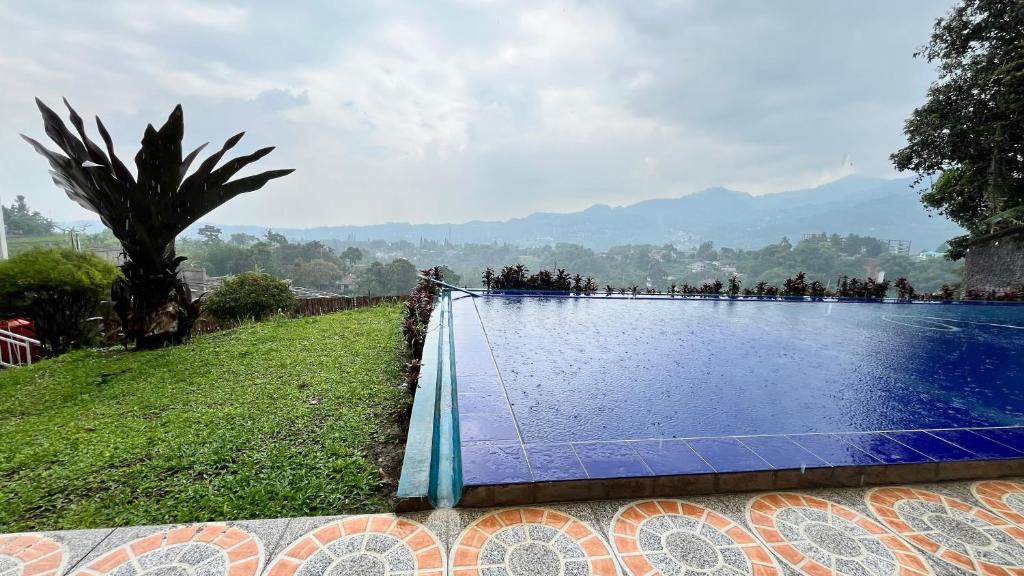 a large swimming pool with people standing around it at Villa Kay Height in Kopo 2