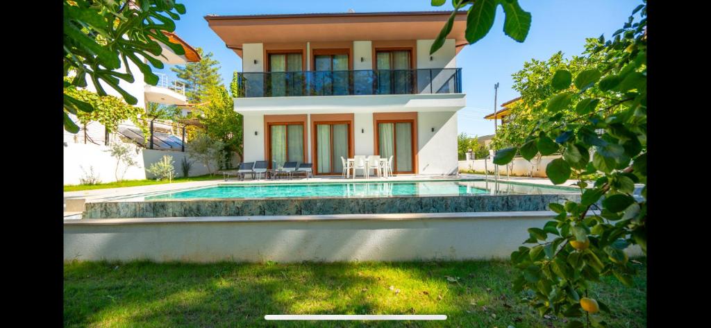 a house with a swimming pool in front of a house at Villa Musa in Marmaris