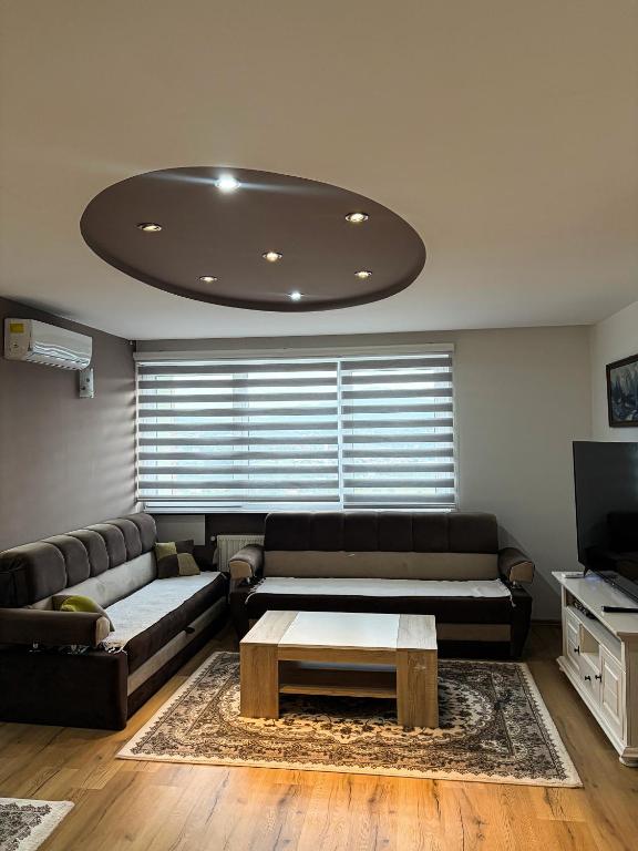 a living room with a couch and a coffee table at Harmony Rooms & Apartments in Vogošća