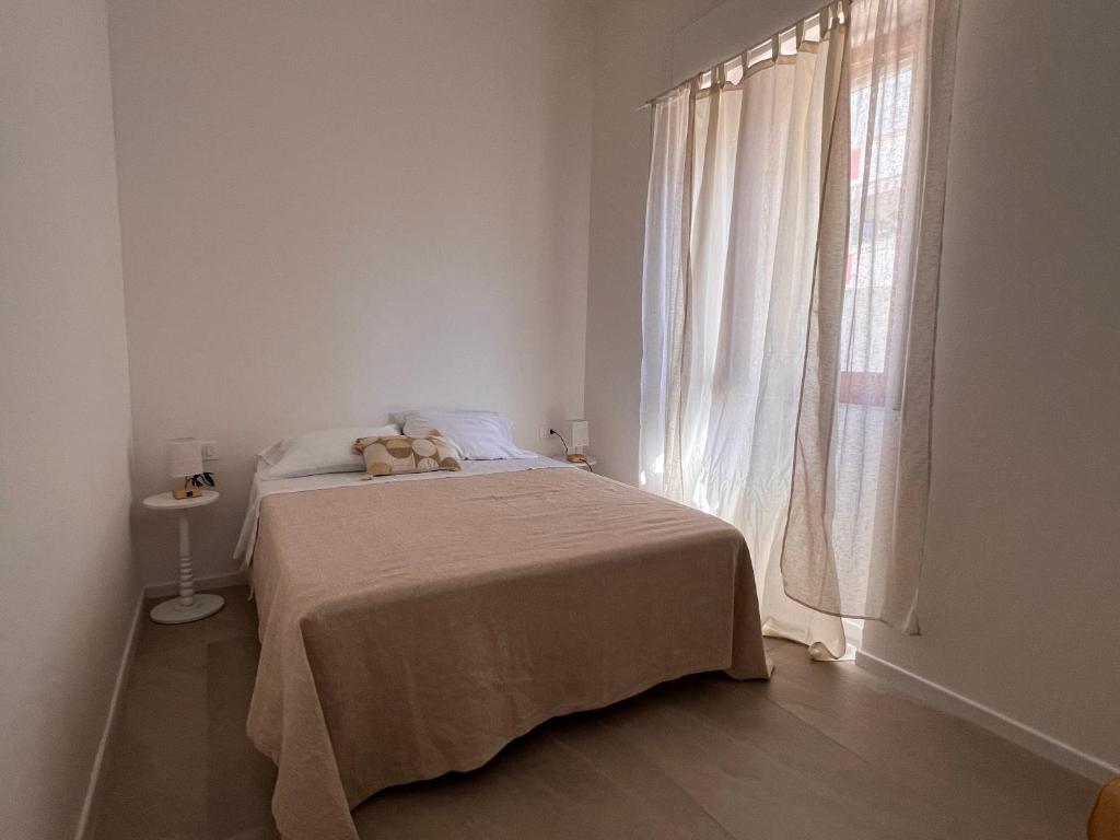 a bedroom with a bed with a teddy bear on it at Alessandra guest house in Alghero