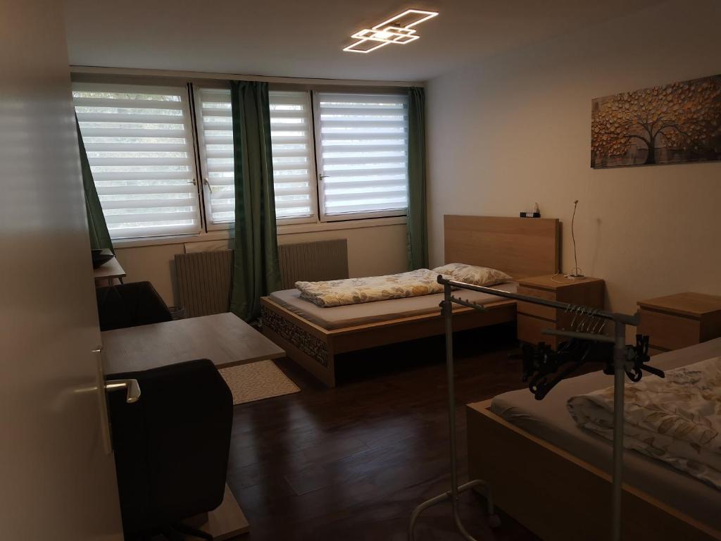 a room with two beds and a window at Monteurwohnung Hoffmann in Heilbronn