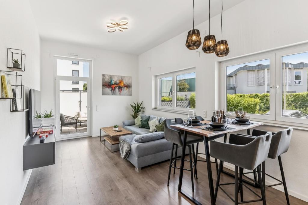 a living room with a table and a couch at Cozy Apartment Central Kitchen Balcony in Frechen