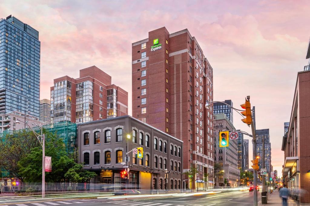 a rendering of a city street with a tall building at Holiday Inn Express Toronto Downtown by IHG in Toronto