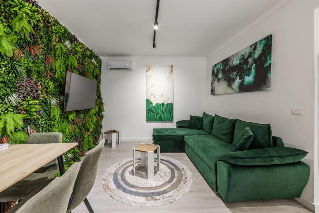 a living room with a green couch and a table at Green Luxe Suite 1 by PikHost in Shkodër