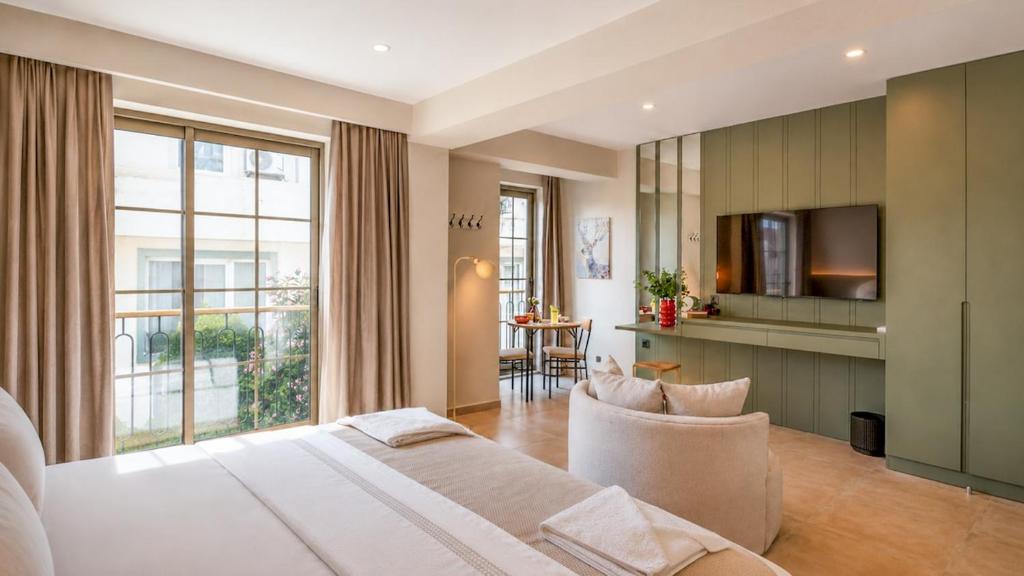 a bedroom with a bed and a living room at Luz Suites in Kaş
