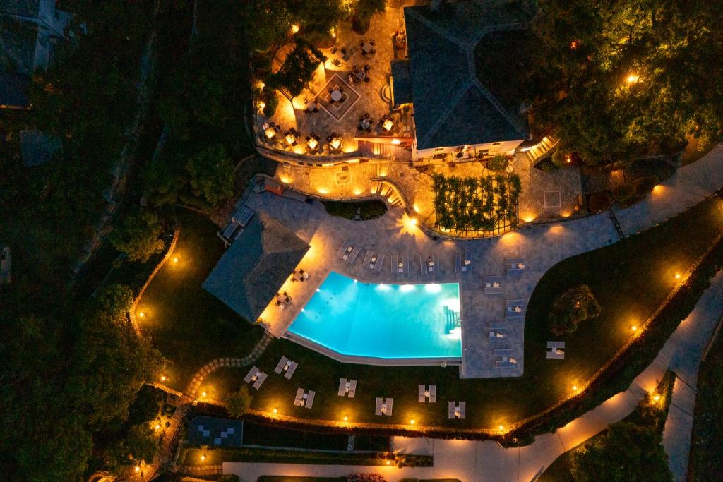 an overhead view of a pool at night with lights at Tilia Resort in Mouresi
