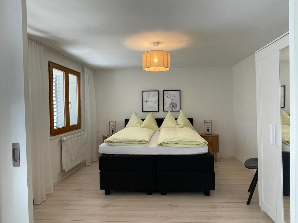 a bedroom with a bed and a chandelier at Apartments Soldanella in Leukerbad