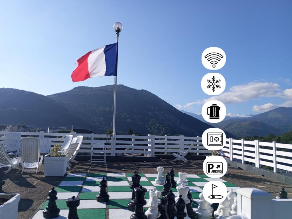 a chess board with a flag in the background at Hôtel Christina Lourdes in Lourdes
