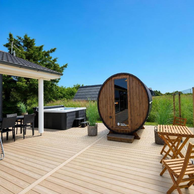 a wooden deck with a large wooden circle on it at Feriehus 1121 in Ringkøbing