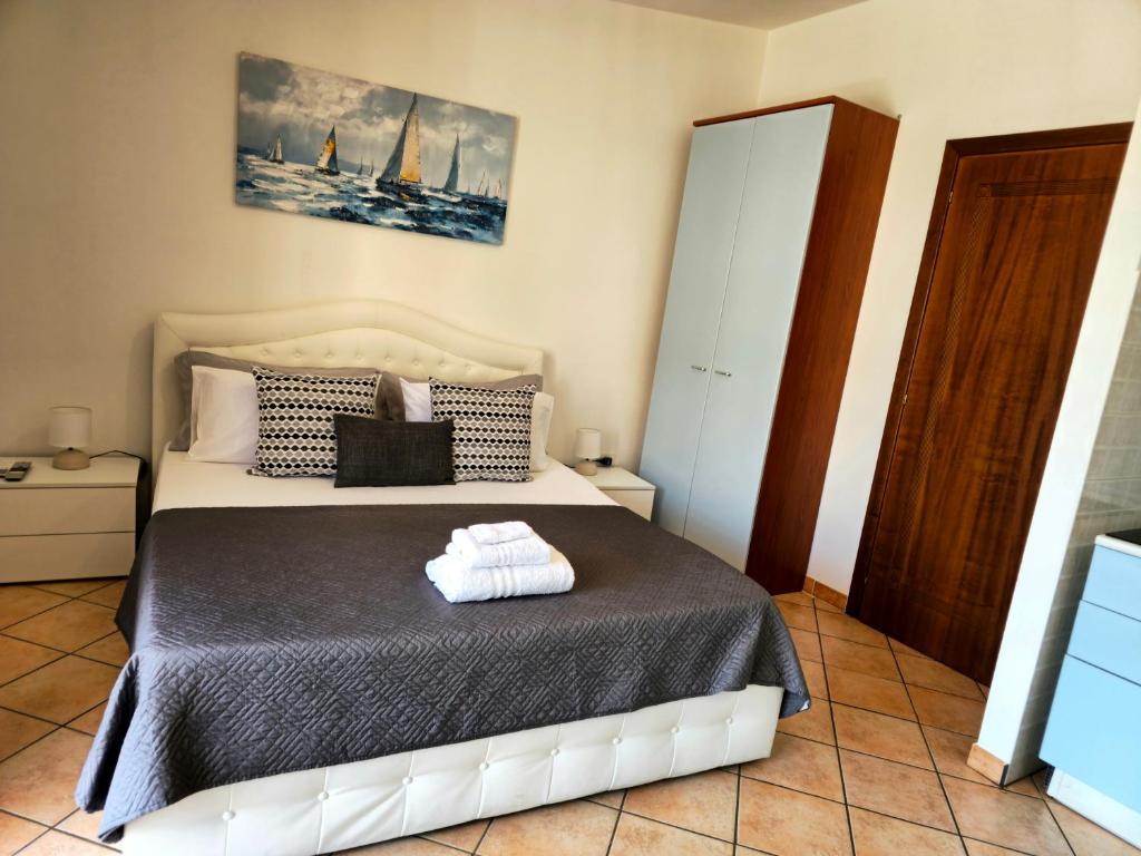 a bedroom with a bed with a black blanket at Casa Giulia Olbiamare in Olbia