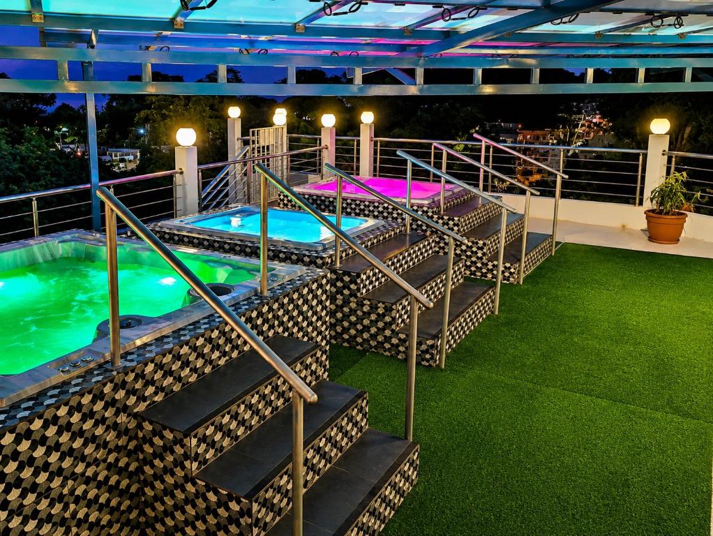 a set of stairs leading to a swimming pool at night at EDMA APARTAHOTEL in Santa Bárbara de Samaná